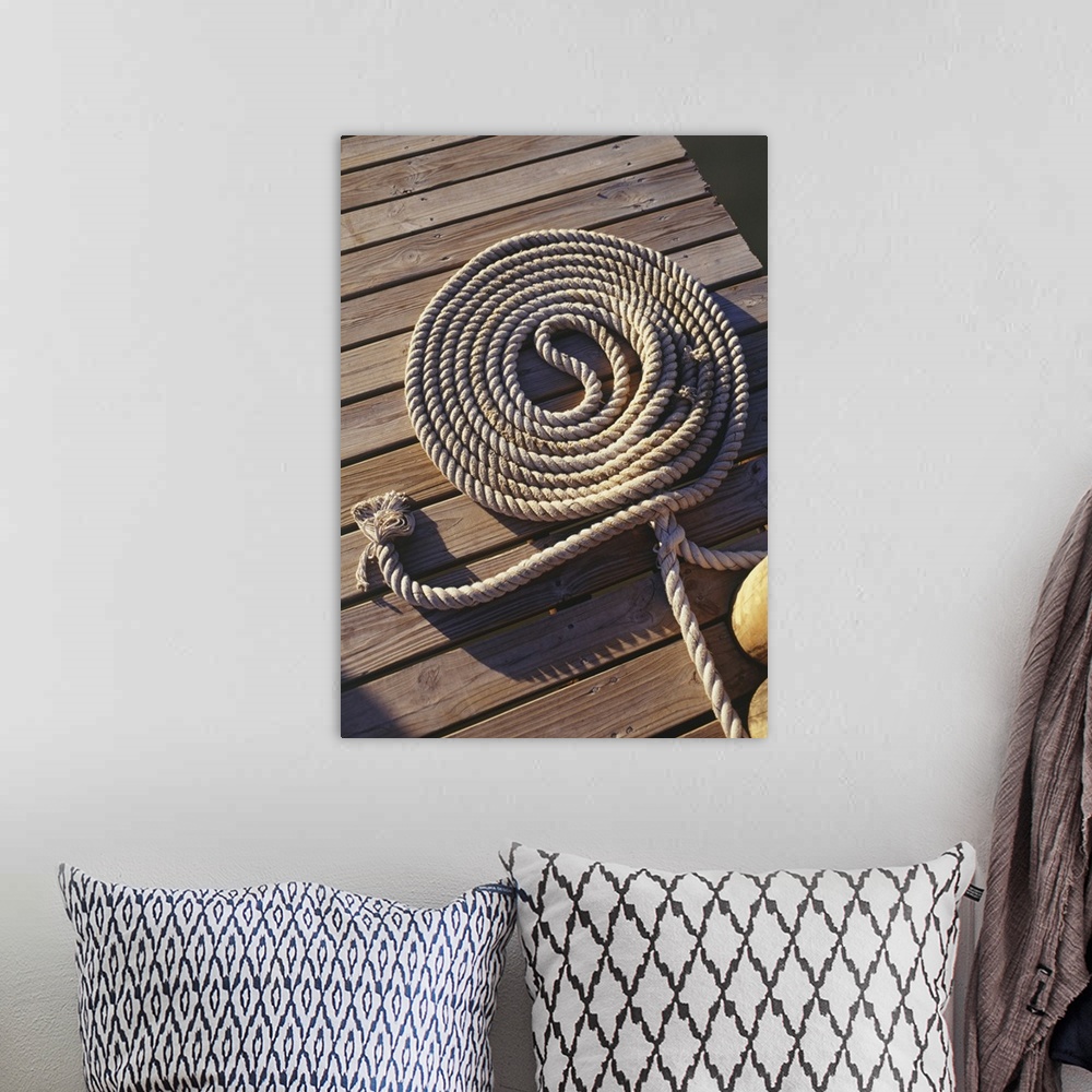 A bohemian room featuring Coil of rope lying on wooden pier, elevated view