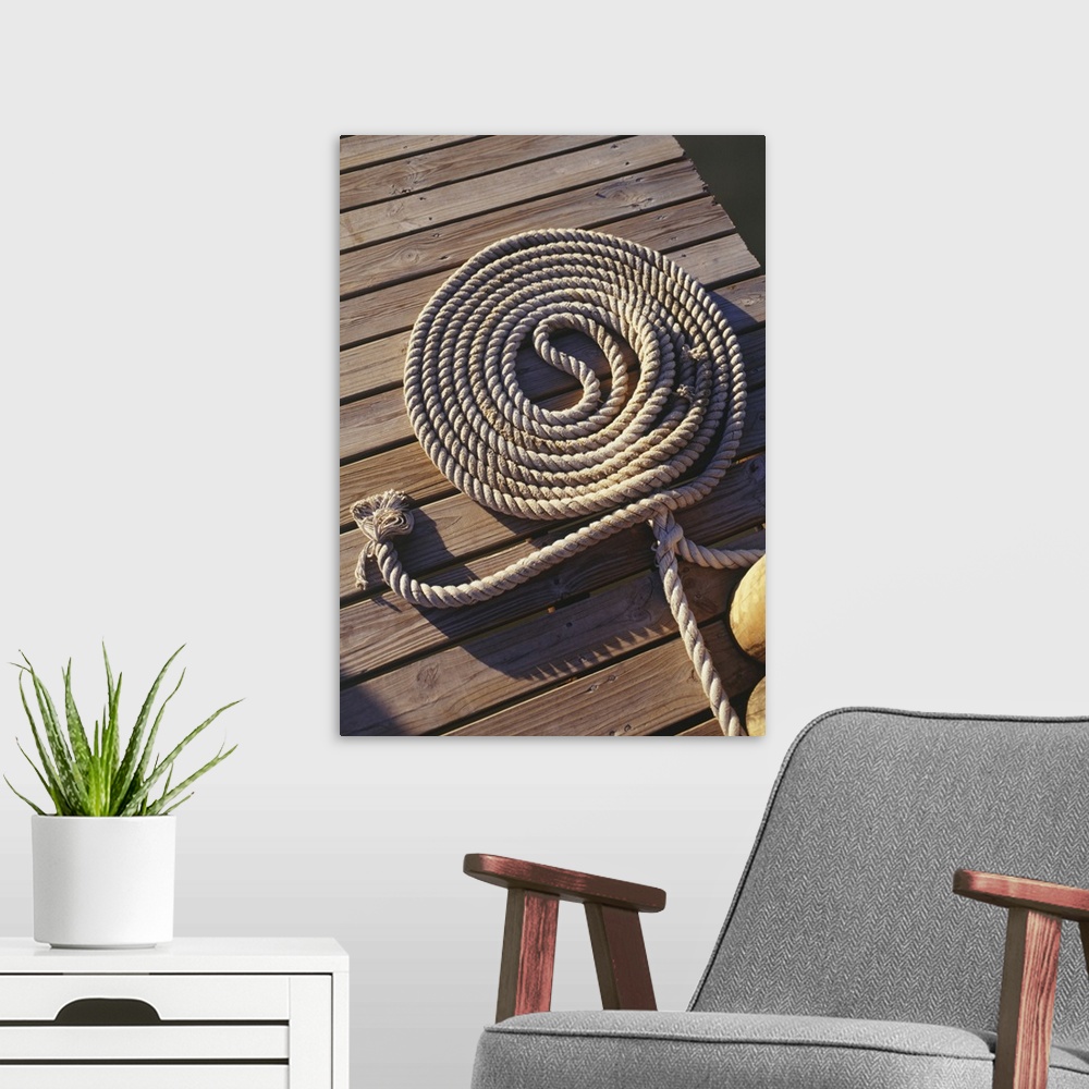 A modern room featuring Coil of rope lying on wooden pier, elevated view