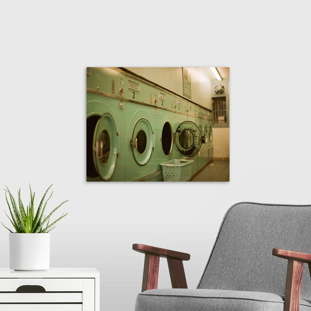 A modern room featuring An old but classic looking coin laundry.