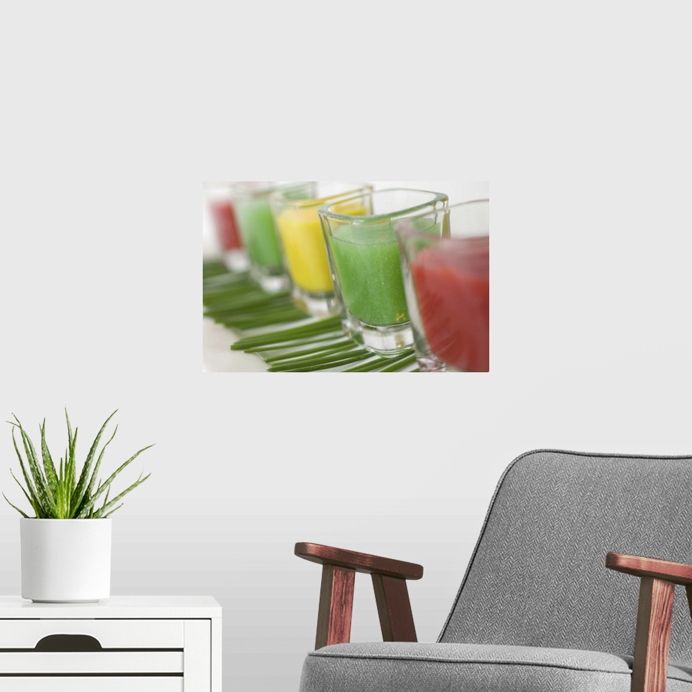 A modern room featuring Cold soups in shot glasses