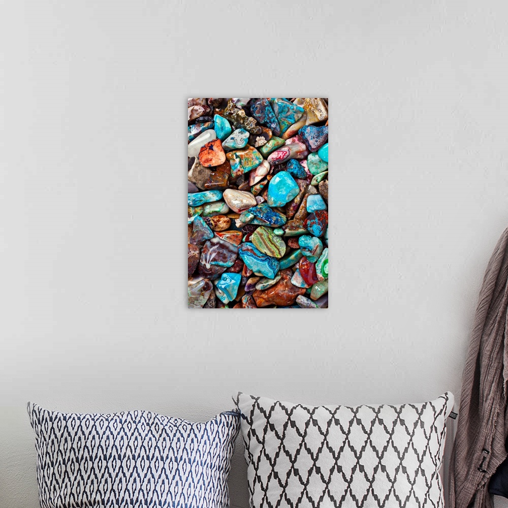 A bohemian room featuring Large close-up photograph focuses on an abundance of vibrantly tinted smooth rocks as they sit ne...