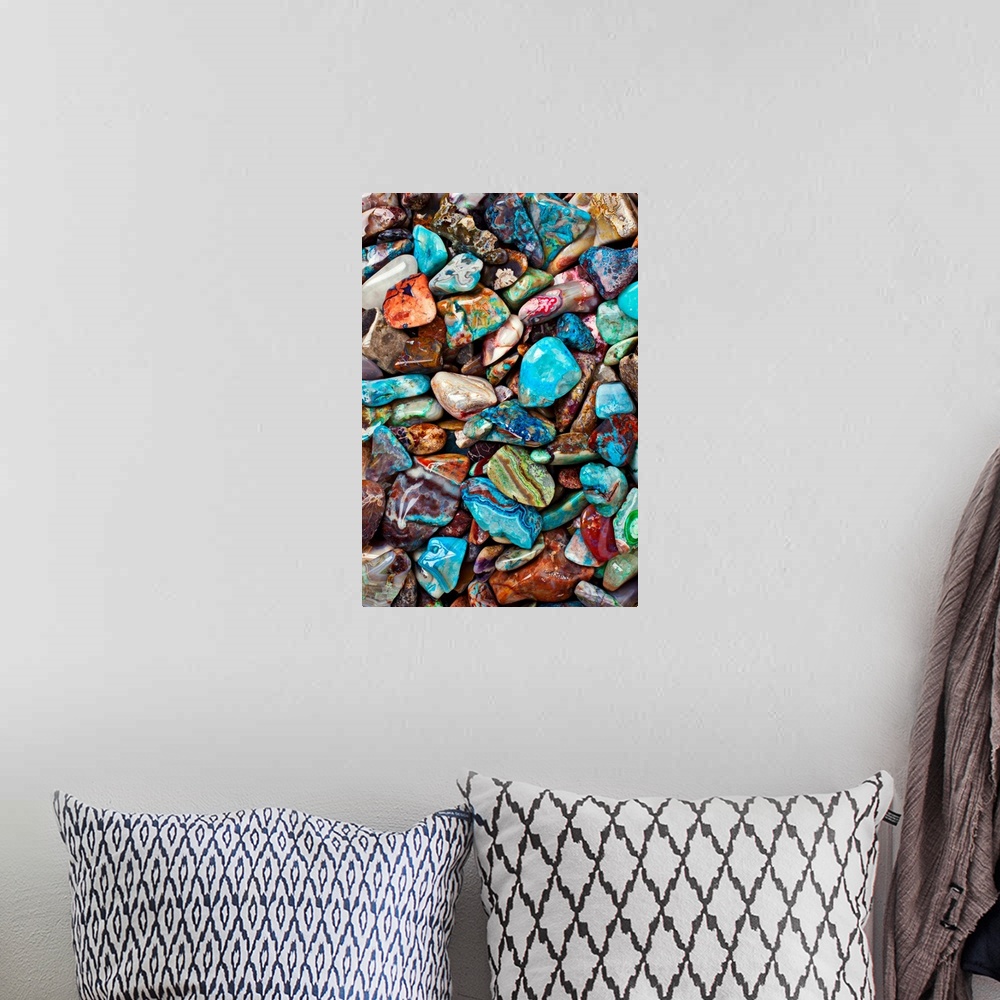 A bohemian room featuring Large close-up photograph focuses on an abundance of vibrantly tinted smooth rocks as they sit ne...