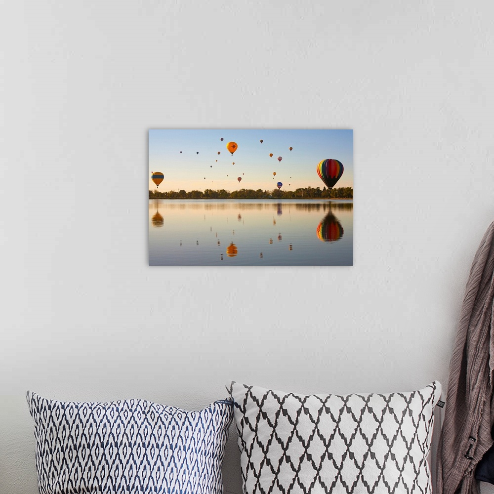 A bohemian room featuring Colorful air balloons reflected in lake.