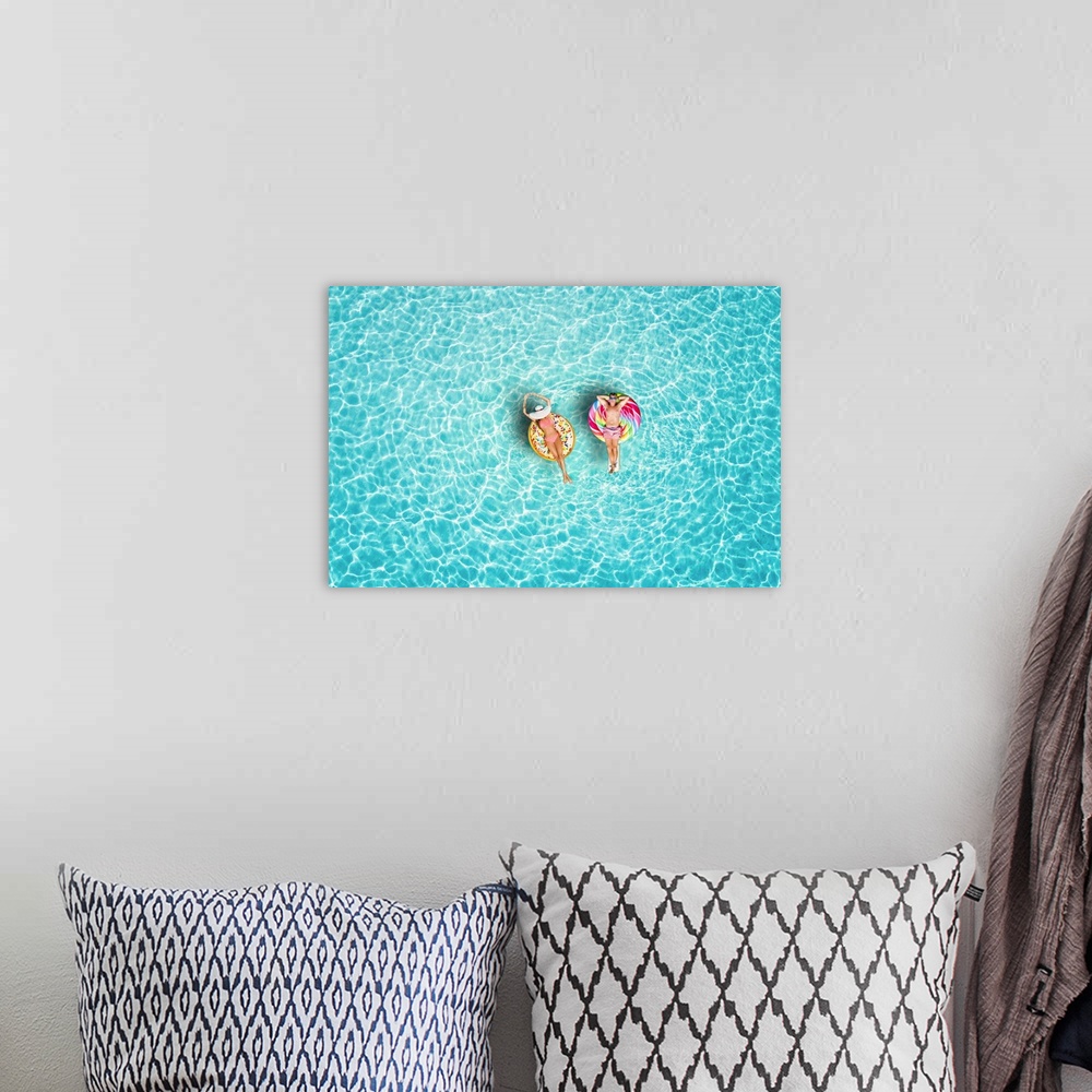 A bohemian room featuring A happy vacation couple in swimsuits enjoys the tropical sun of the Maldives on colorful floats o...