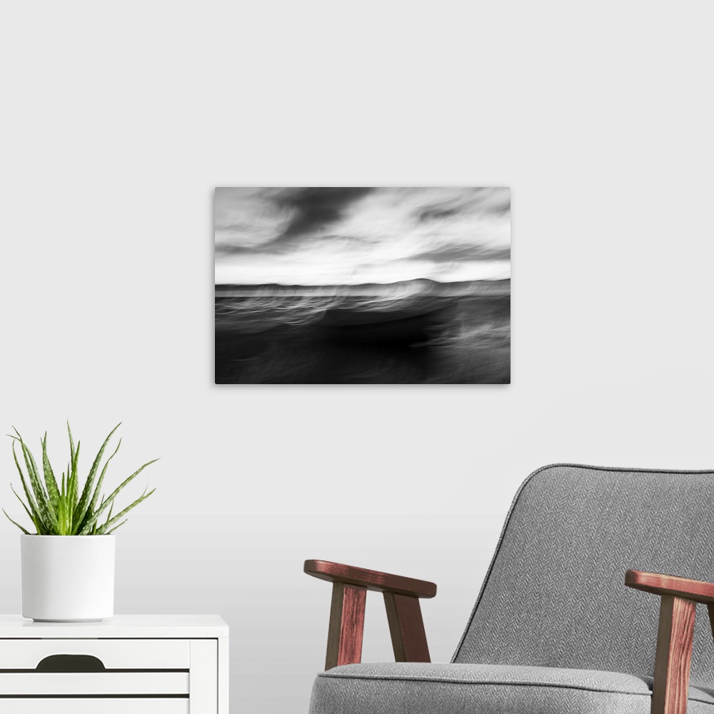 A modern room featuring Monochrome intentional camera movement blurs of coastal impressionist style image in morning ligh...