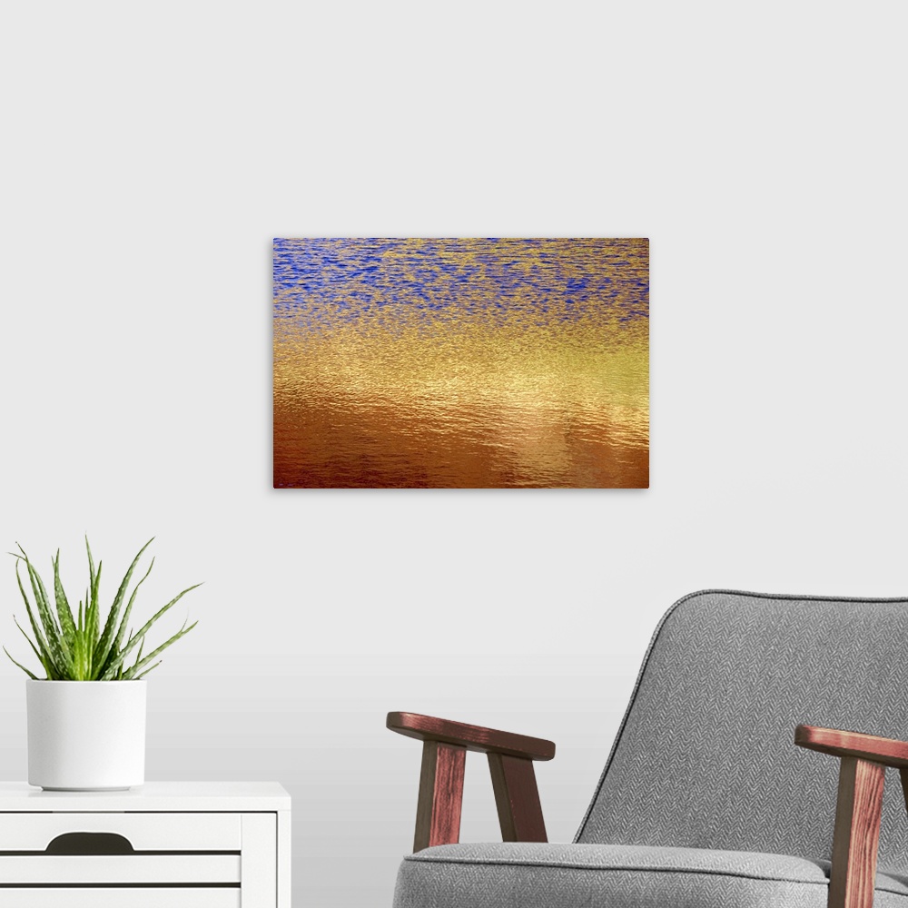 A modern room featuring The photograph of a setting sunos light shimmering on a lake takes on an abstract artwork look in...