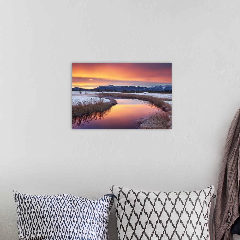 A bohemian room featuring Colorful sunrise with the Alps in background.
