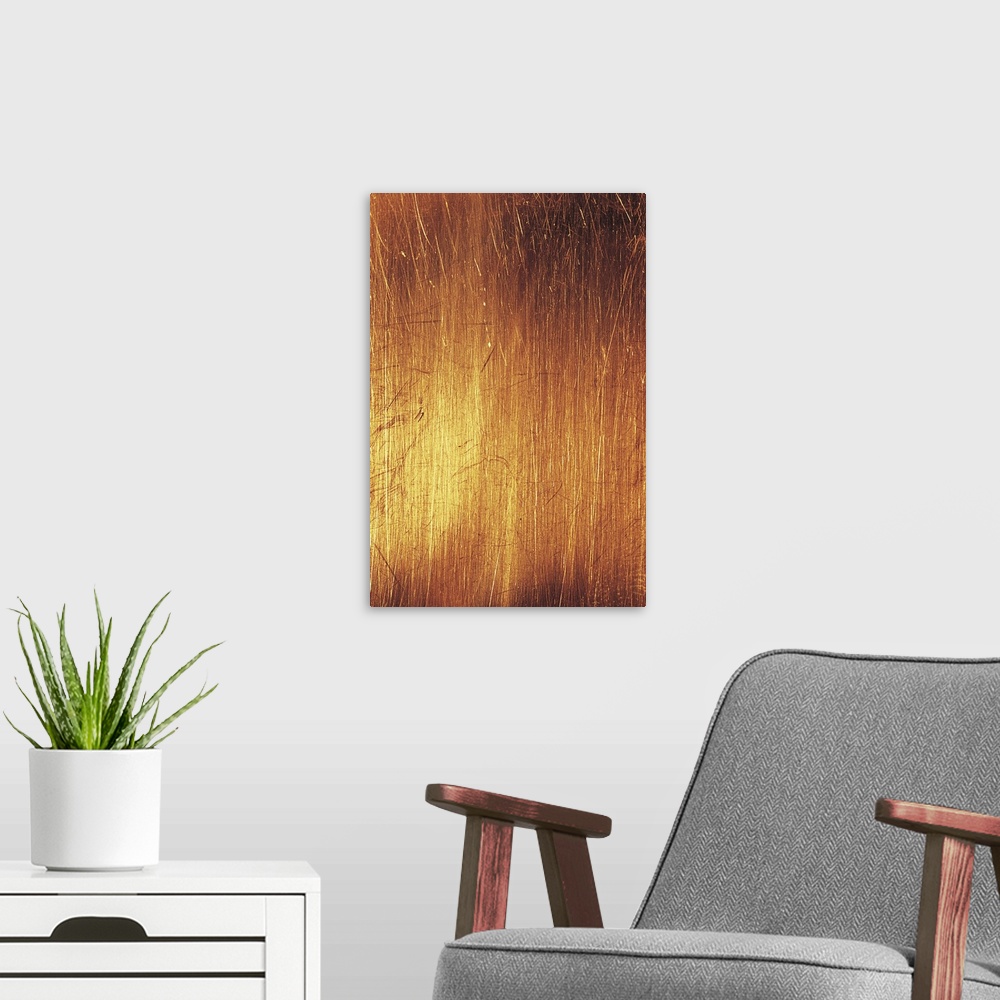 A modern room featuring Vertical abstract painting of different lines etched together closely with warm tones.