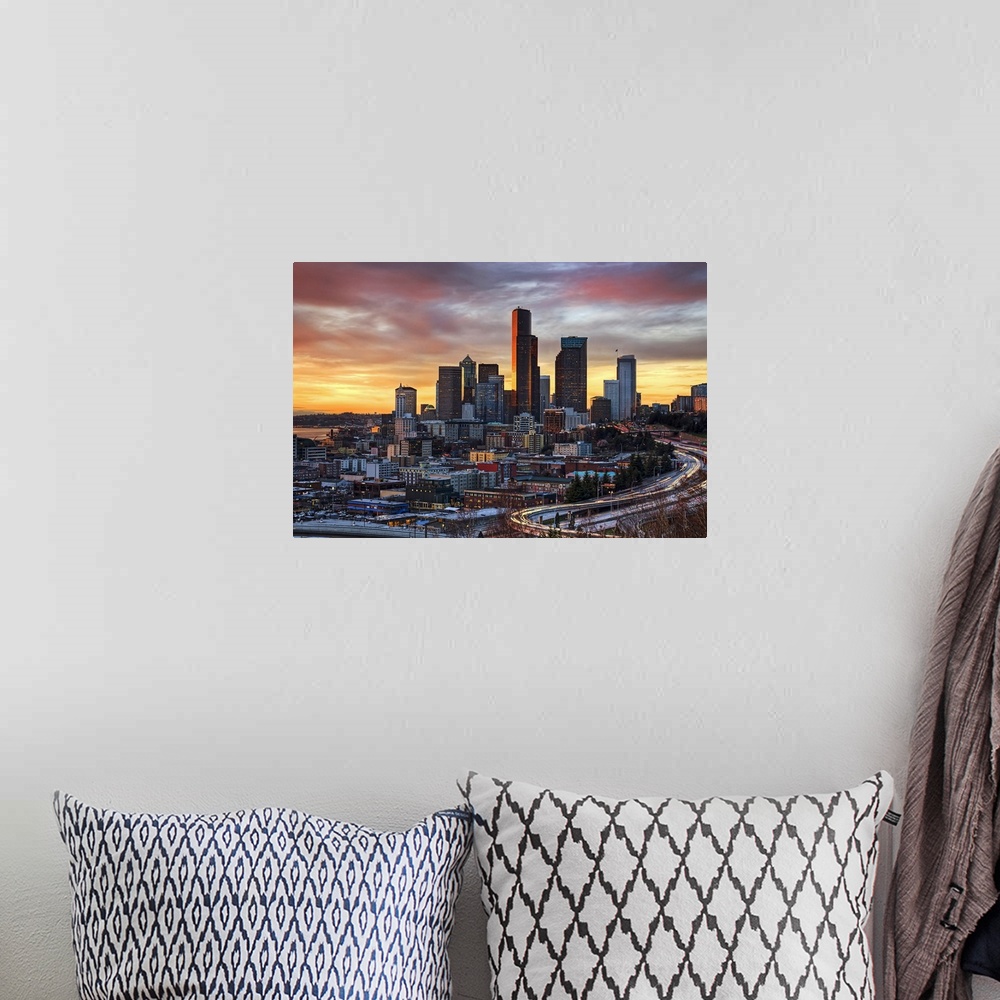 A bohemian room featuring Wall docor of the Seattle downtown buildings at sunset with cars lit up and driving on the highwa...
