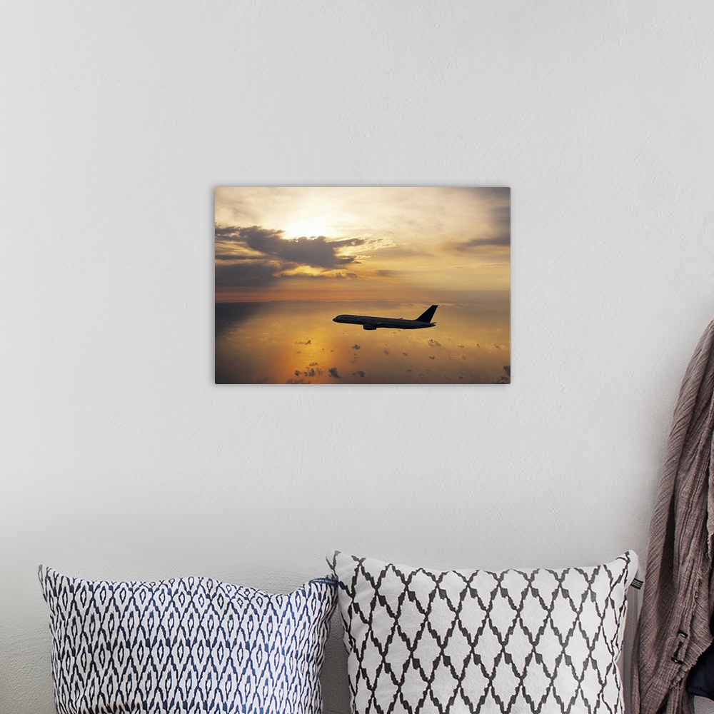 A bohemian room featuring Commercial Aeroplane Flying Above the Sea at Dusk