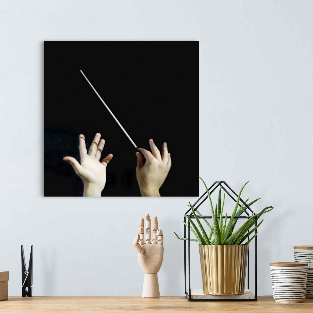 A bohemian room featuring Conductor, close-up of hands
