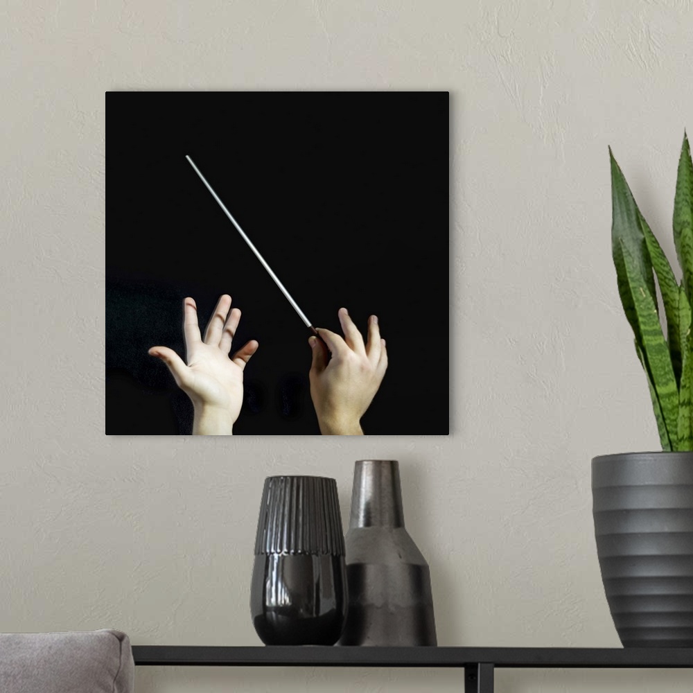 A modern room featuring Conductor, close-up of hands