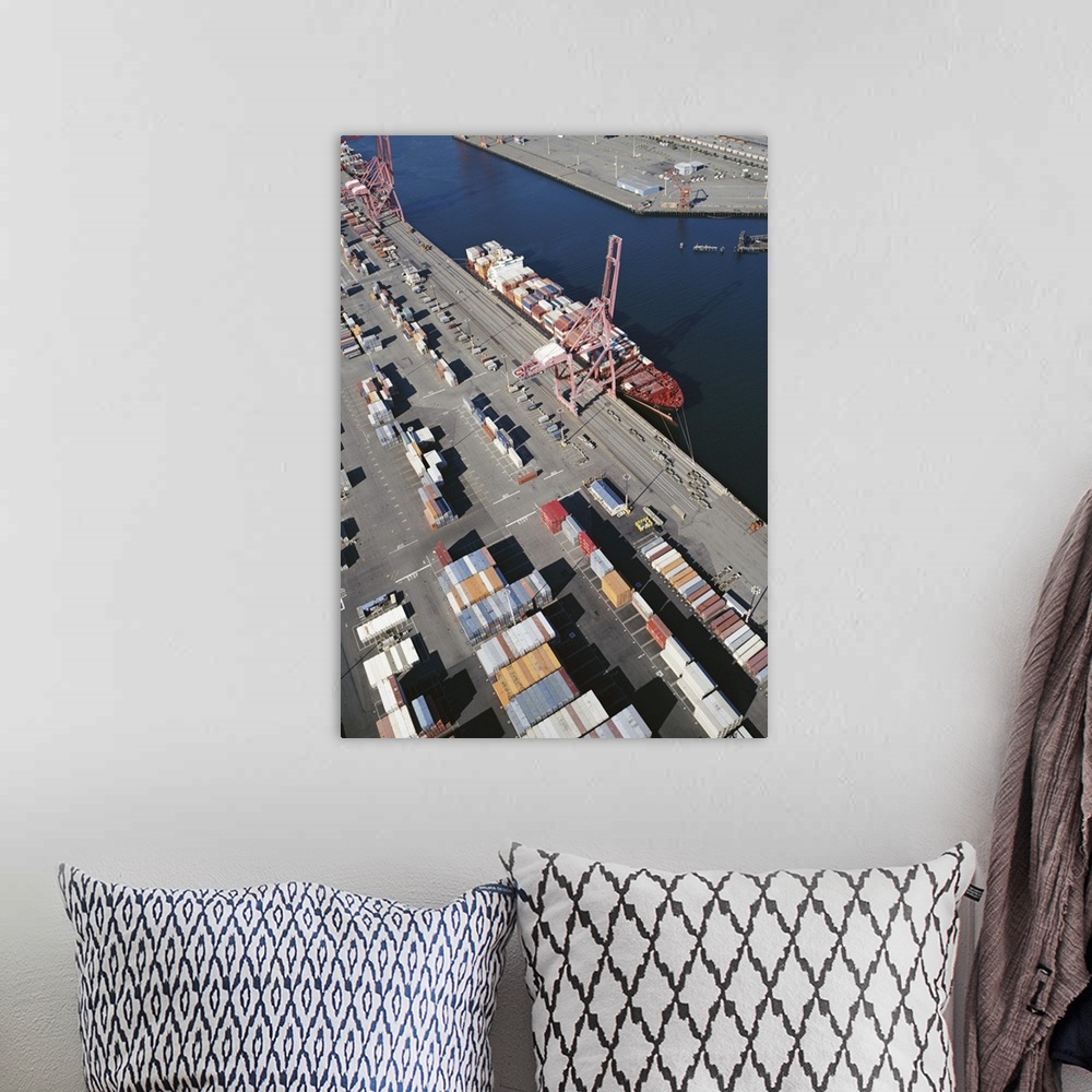 A bohemian room featuring Container ship alongside commercial dock, aerial view