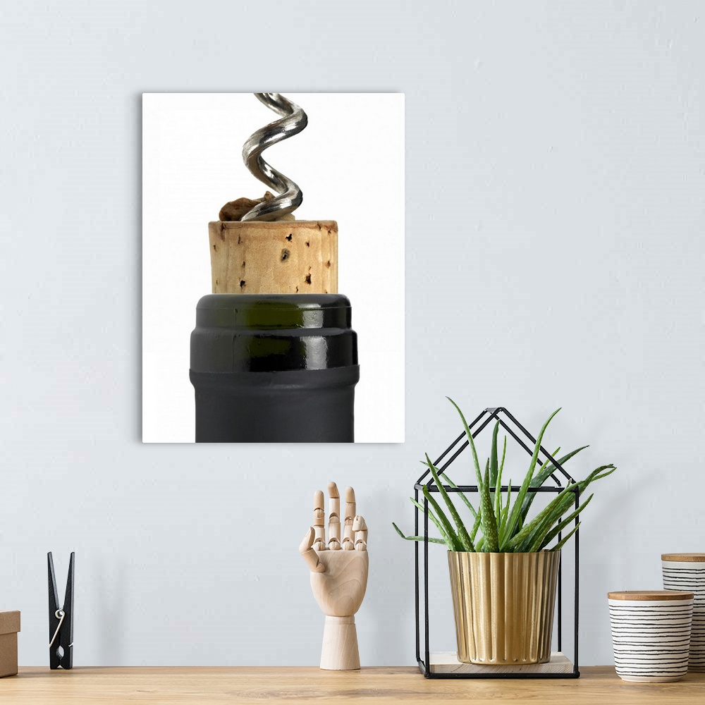 A bohemian room featuring Corkscrew and cork, photographed on white surface. Part of the bottle's neck can be seen too. The...