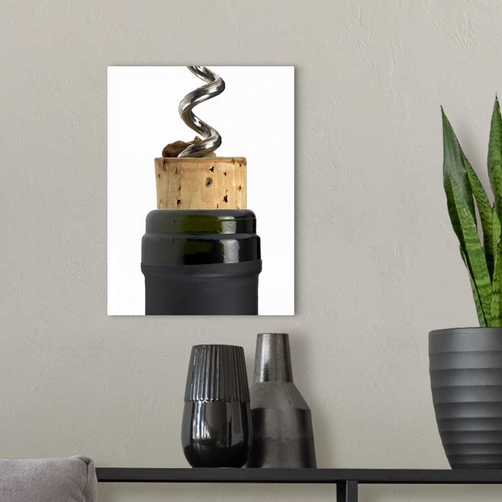 A modern room featuring Corkscrew and cork, photographed on white surface. Part of the bottle's neck can be seen too. The...