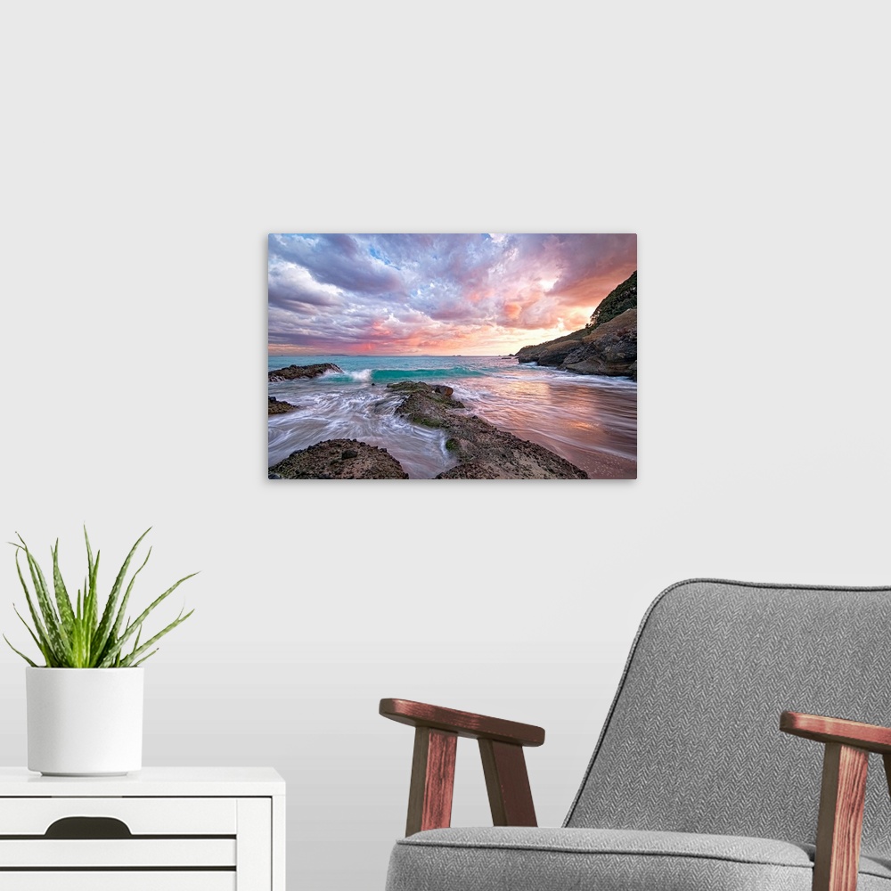 A modern room featuring Photograph of sandy inlet with water rushing in from the ocean under a cloudy sky at sunset.