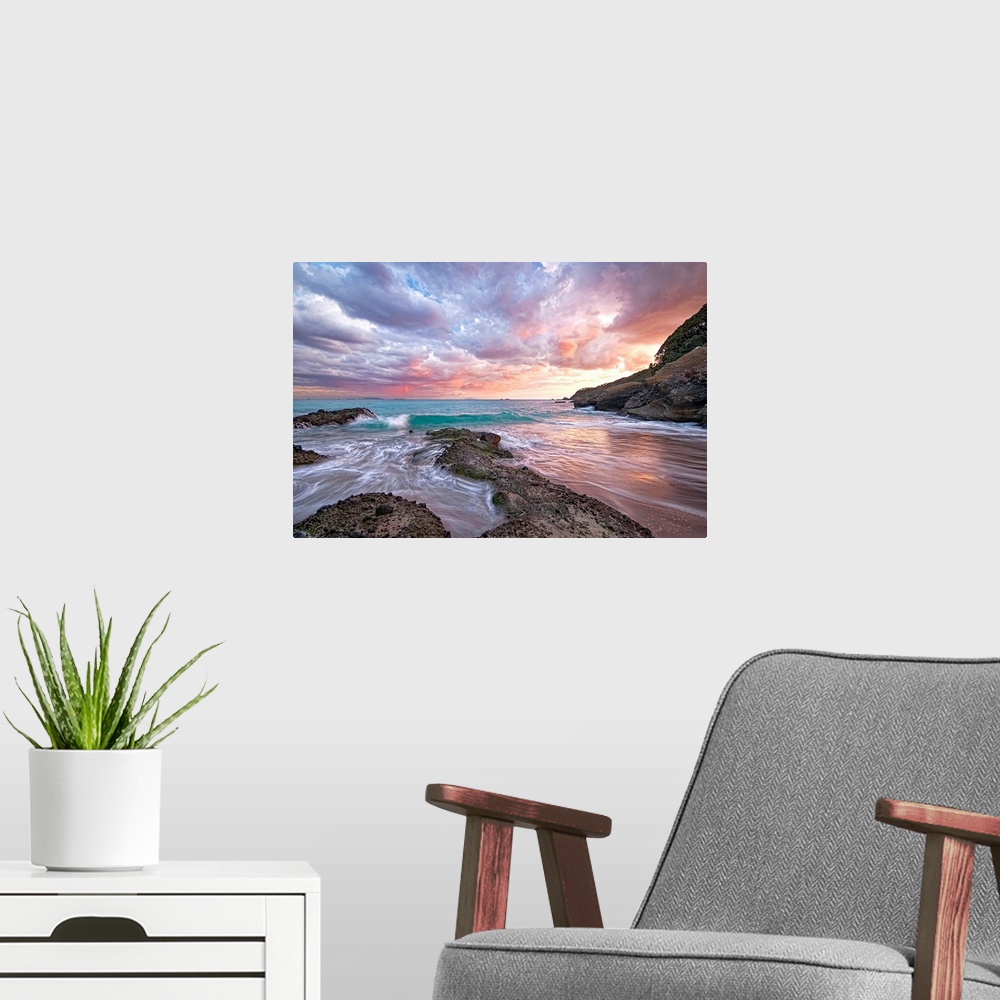 A modern room featuring Photograph of sandy inlet with water rushing in from the ocean under a cloudy sky at sunset.