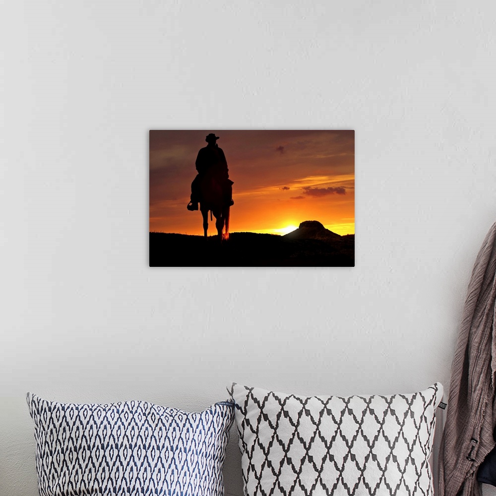 A bohemian room featuring Contour cowboy with horse in the sunset. In the background, a table mountain.