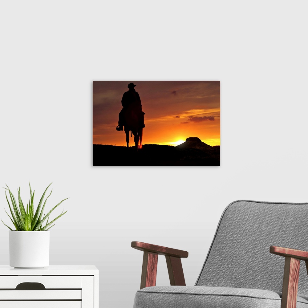 A modern room featuring Contour cowboy with horse in the sunset. In the background, a table mountain.