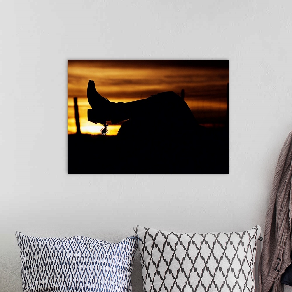 A bohemian room featuring Cowboy's Boot And Spur Silhouetted At Sunrise
