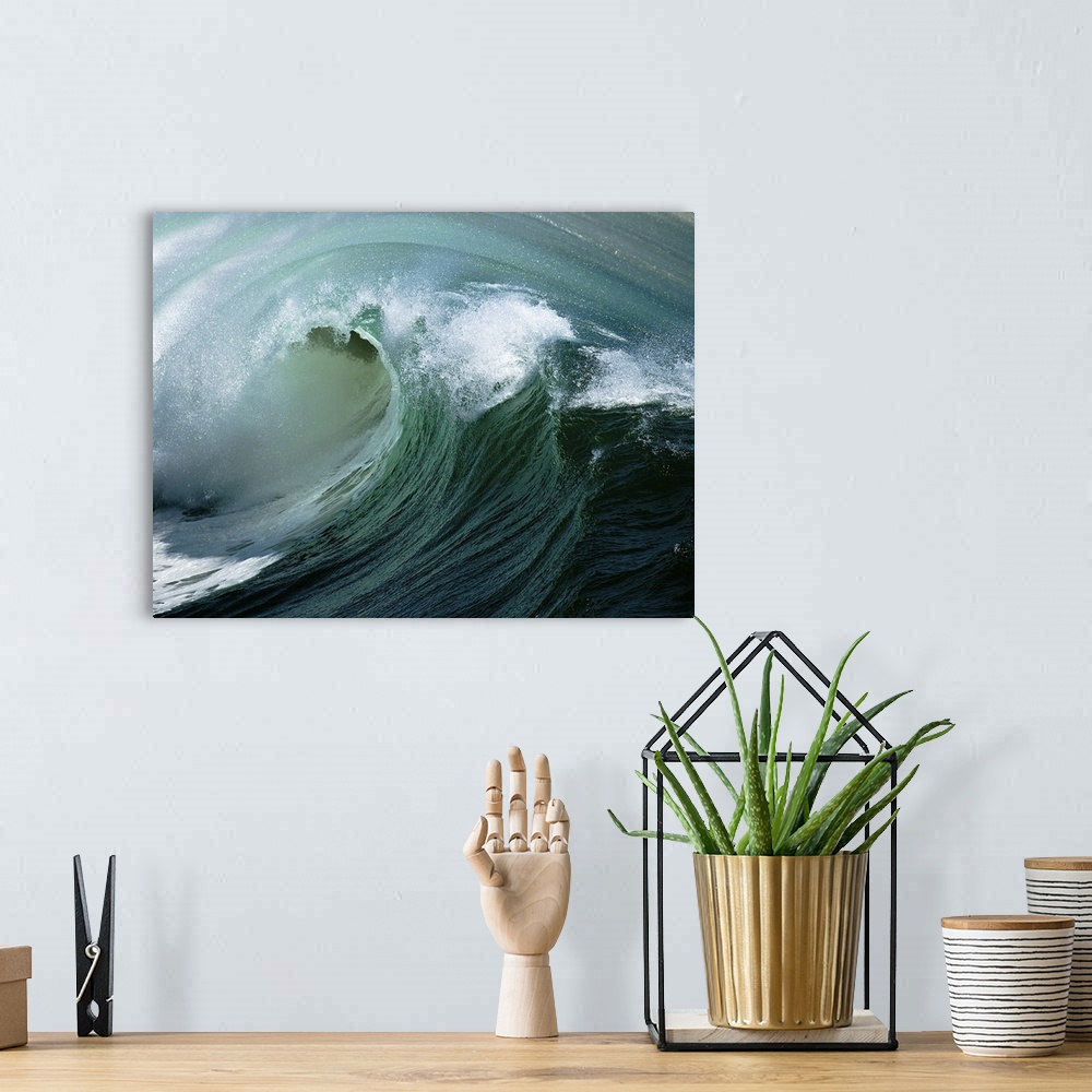A bohemian room featuring Curl of big wave off of coast of California.