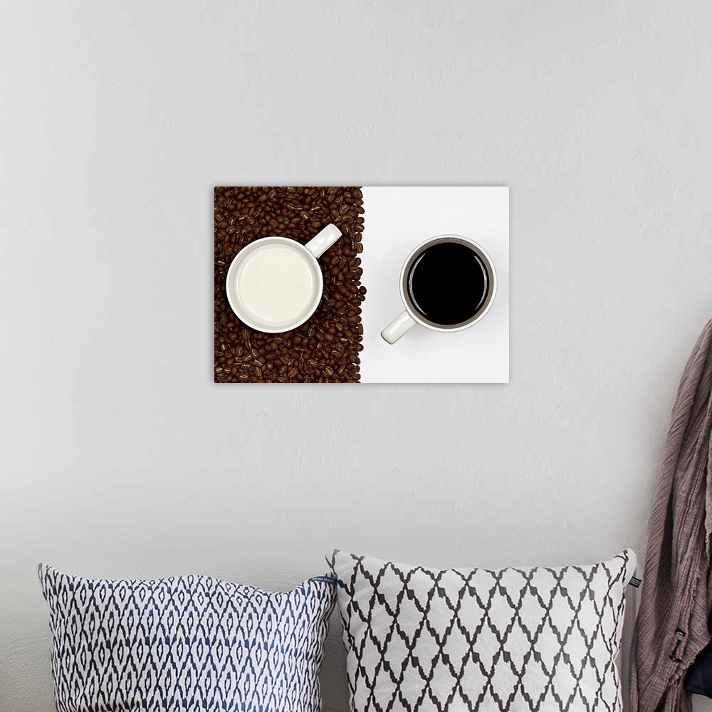 A bohemian room featuring Cup of black coffee on white background and  cup of white milk on  layer of coffee beans.