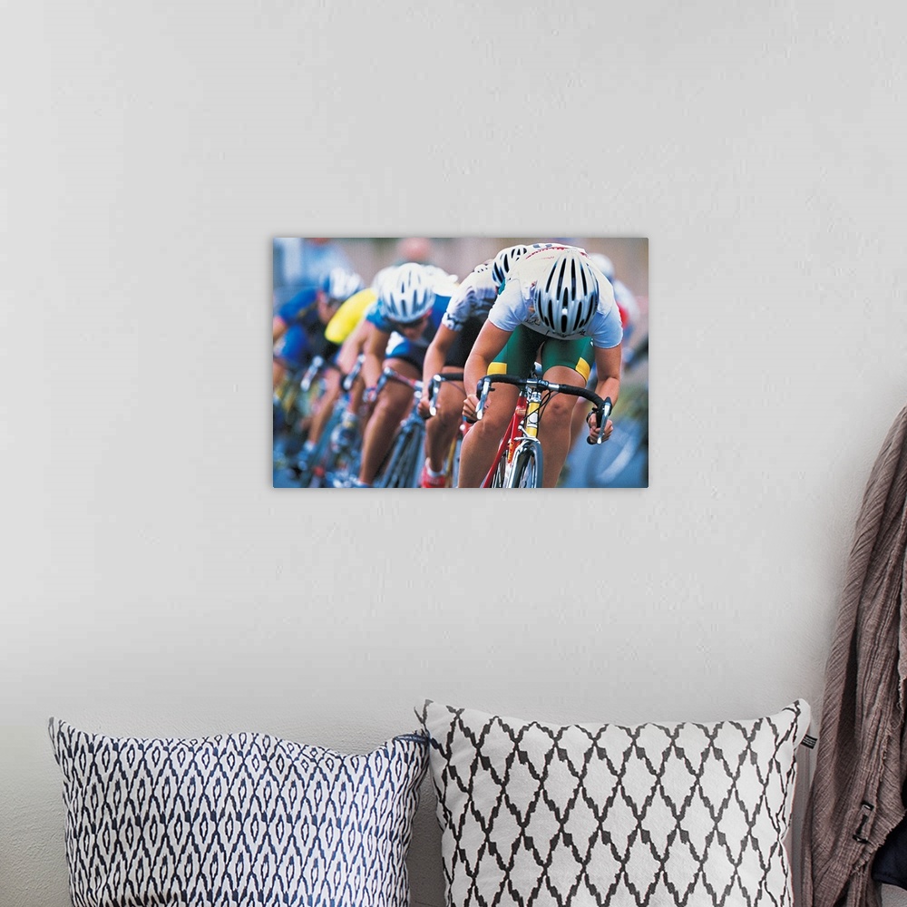 A bohemian room featuring Photograph of a several racers in a bicycle race hurrying towards the finish line, with their hea...