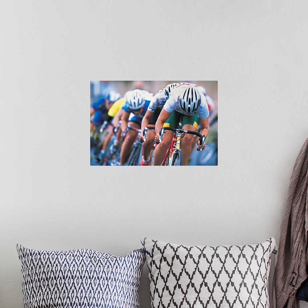 A bohemian room featuring Photograph of a several racers in a bicycle race hurrying towards the finish line, with their hea...