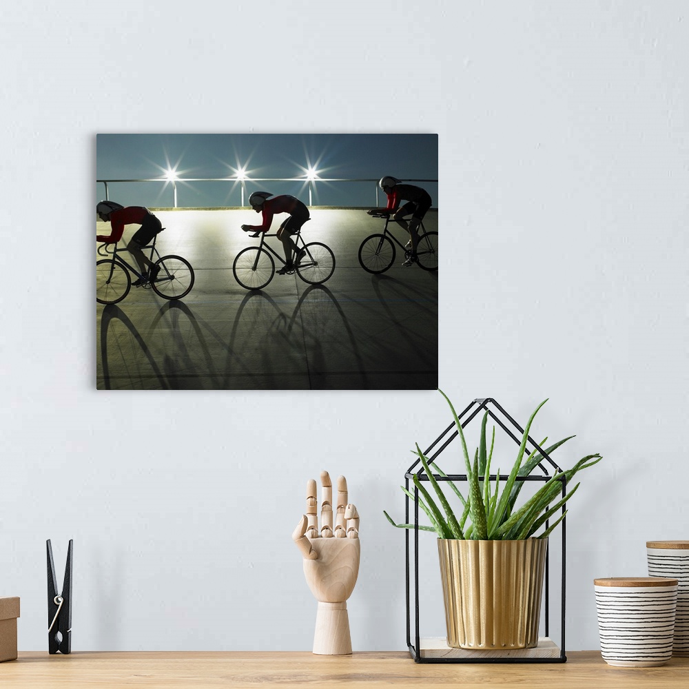 A bohemian room featuring Cyclists on velodrome track at night, side view