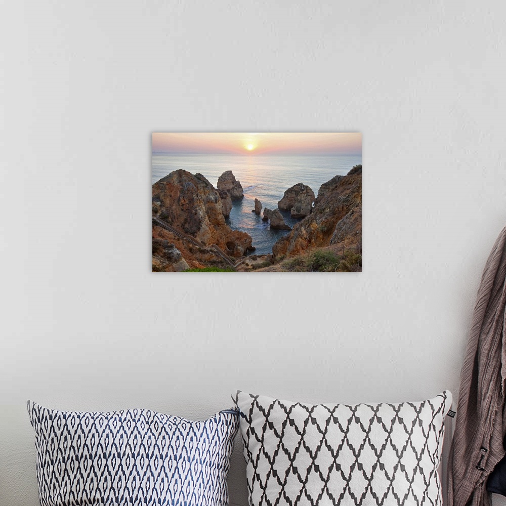 A bohemian room featuring Da Piedade Pontdaawesome rocky cliff formations along ocean in Lagos, Argarve, Portugal.