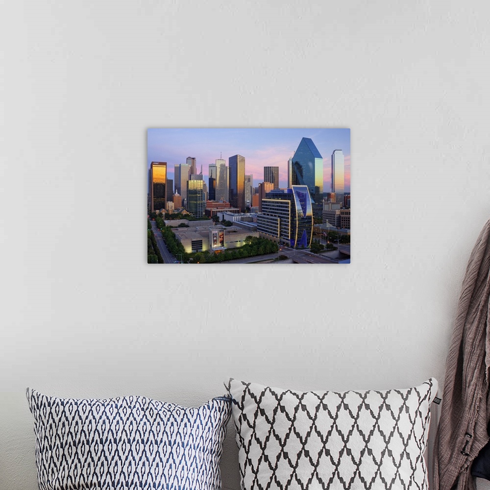 A bohemian room featuring Dallas cityscape with several modern skyscrapers reflecting the fading light from the sunset at t...