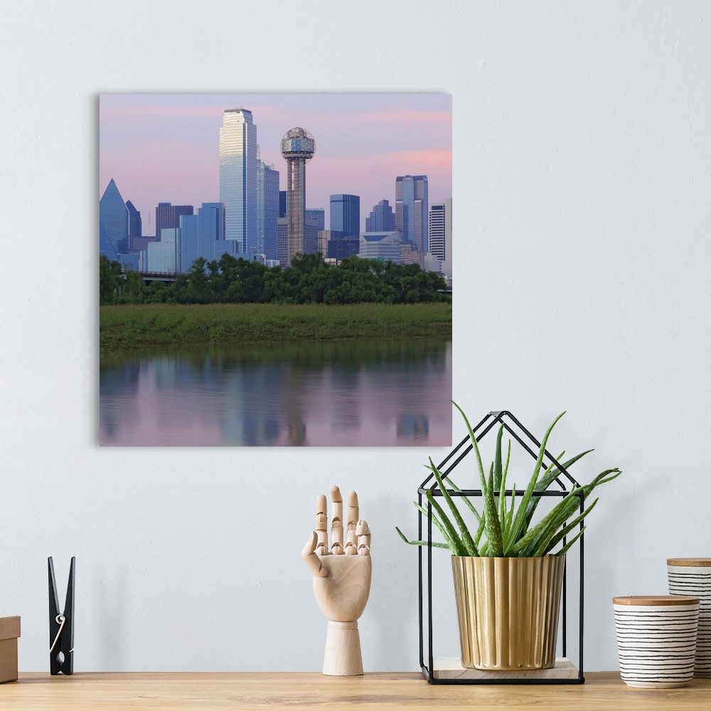 A bohemian room featuring Wall art of the downtown of a Southern city reflected on the water.
