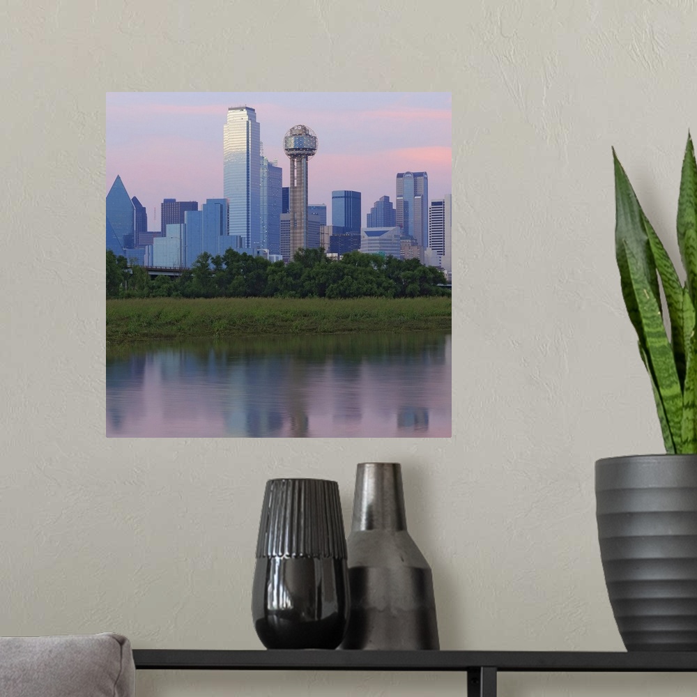 A modern room featuring Wall art of the downtown of a Southern city reflected on the water.