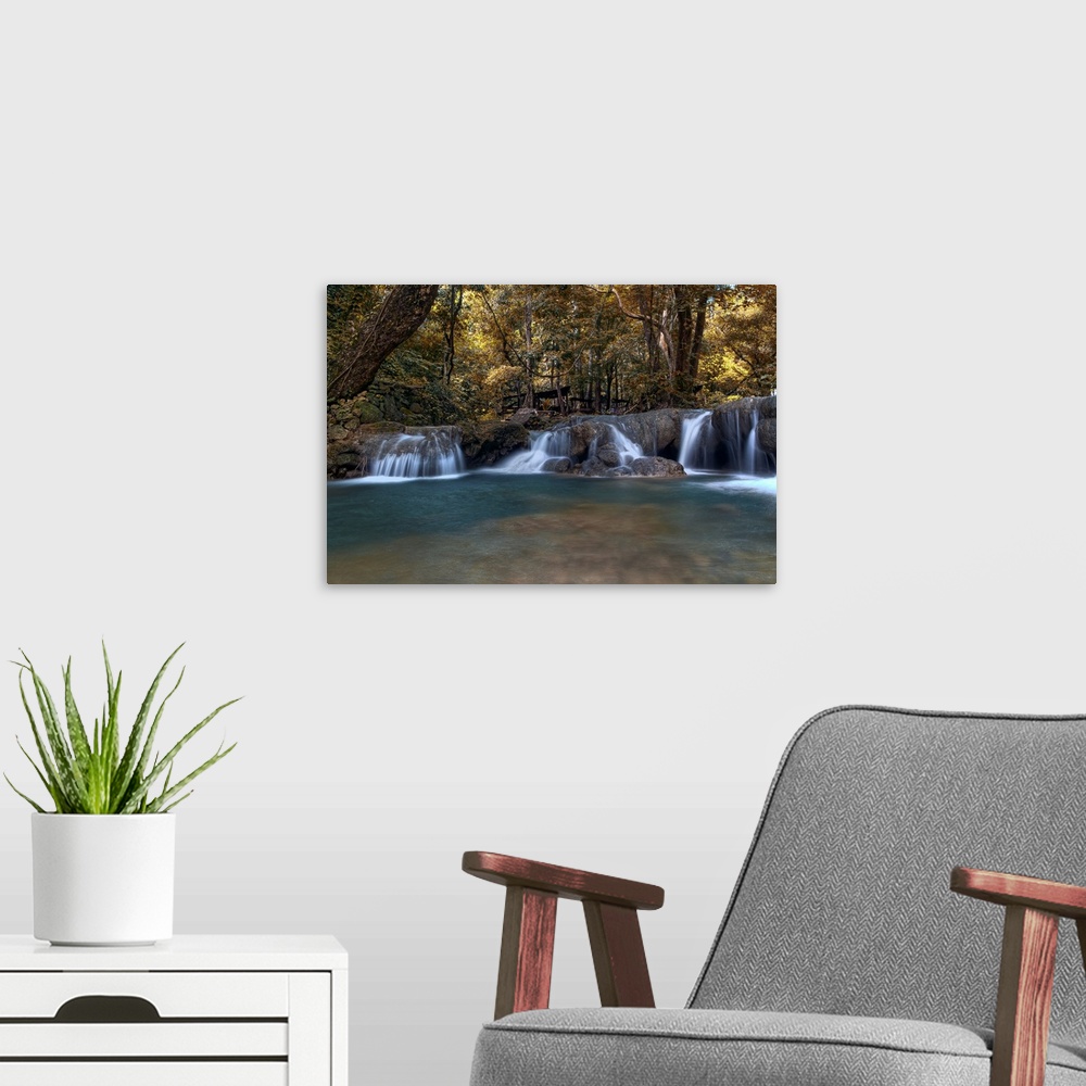 A modern room featuring Big, horizontal photograph of Daranak Falls along the edge of a dense forest in the Province of R...