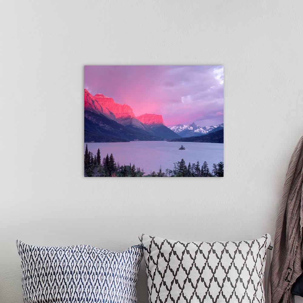 A bohemian room featuring Dawn sunlight illuminates the Rocky Mountains above Saint Mary Lake.
