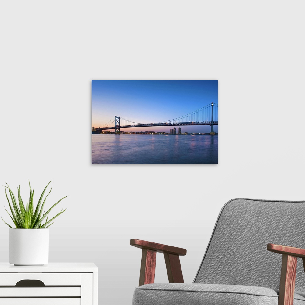 A modern room featuring Delaware River; Ben Franklin Bridge; dusk, I-676/US 30 highways