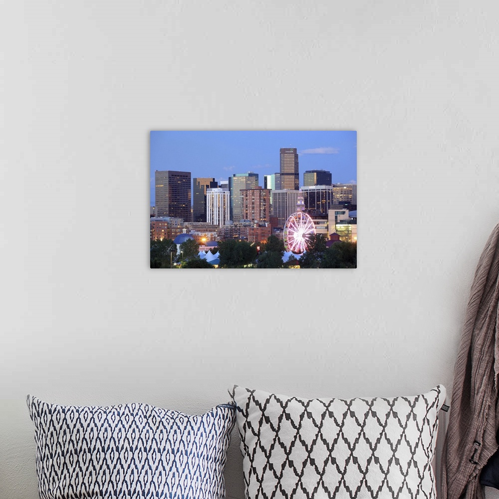 A bohemian room featuring Denver, Colorado skyline at dusk with theme park ride in foreground