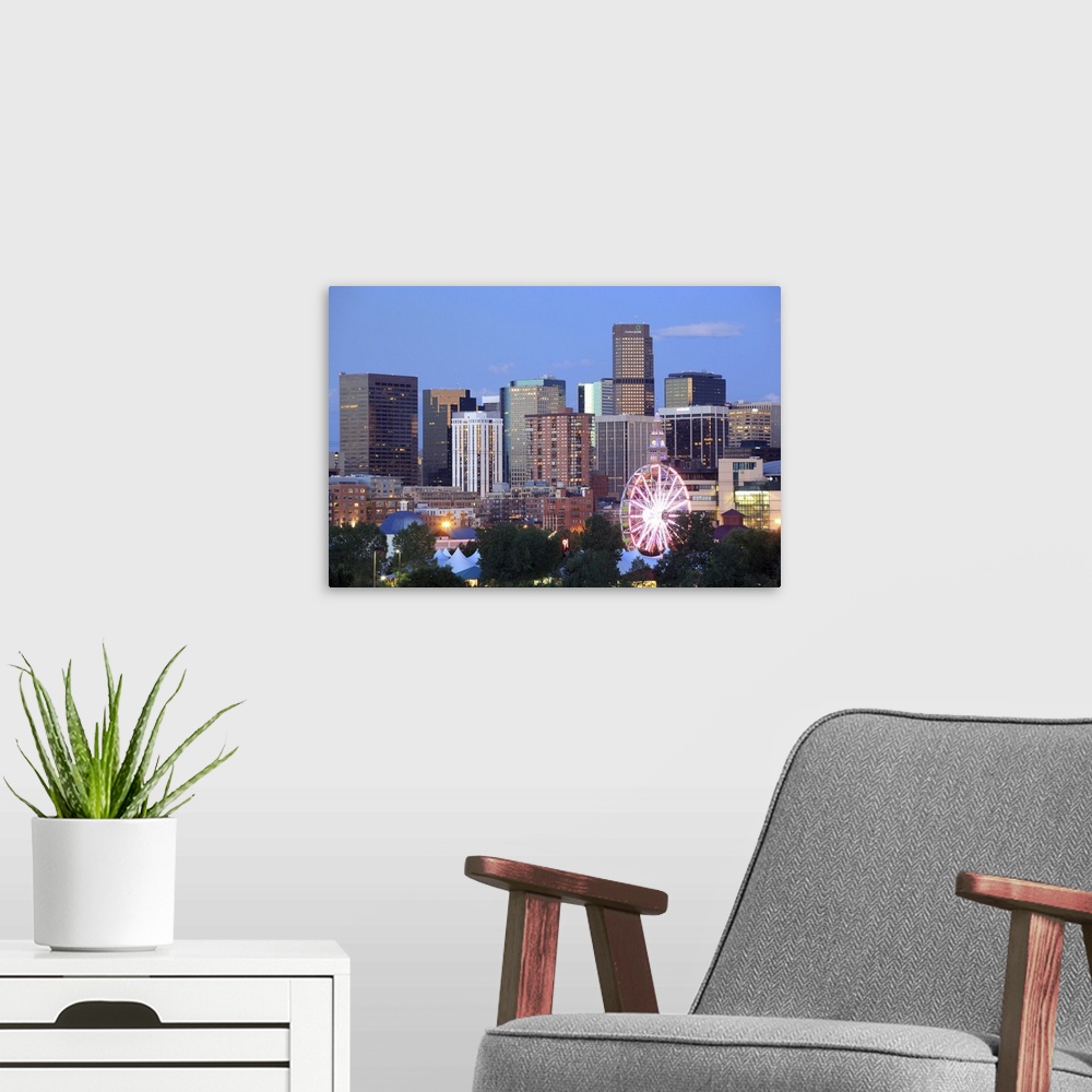 A modern room featuring Denver, Colorado skyline at dusk with theme park ride in foreground