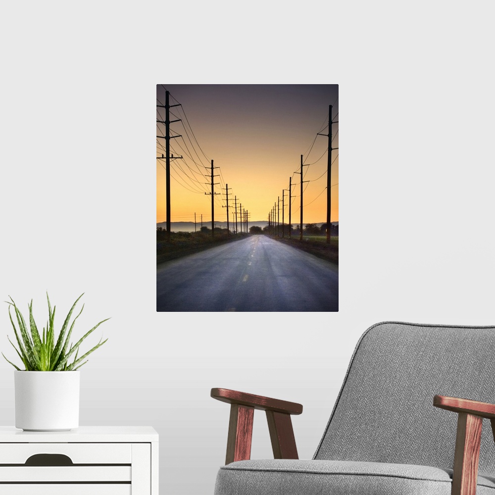 A modern room featuring Desert road and power lines at sunset in California desert.