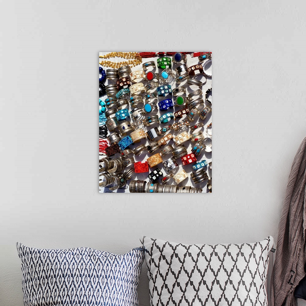 A bohemian room featuring Display of bracelets made of silver and semi-precious stones