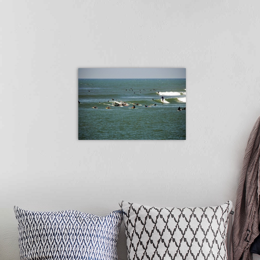 A bohemian room featuring Distant view of a group of people surfing, Malibu, California, USA