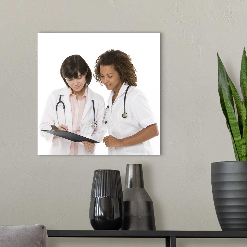 A modern room featuring Doctors looking at clipboard