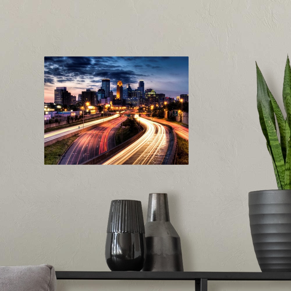 A modern room featuring Giant photograph depicts a busy city filled with skyscrapers and highways brightly lit at night. ...