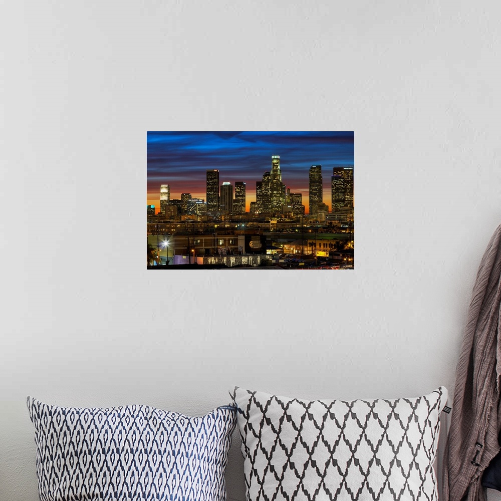 A bohemian room featuring Huge photograph displays a busy city as the sun begins to set on the nicknamed "City of Angels" i...