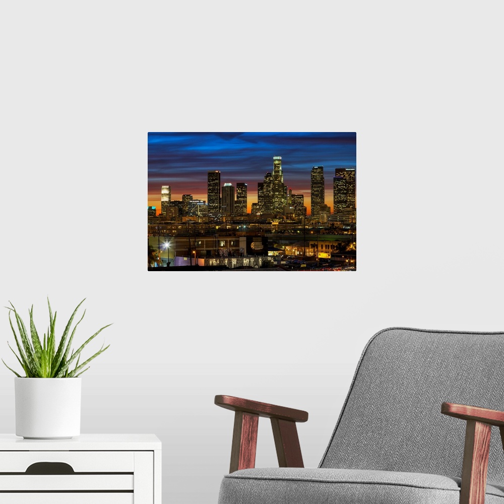 A modern room featuring Huge photograph displays a busy city as the sun begins to set on the nicknamed "City of Angels" i...