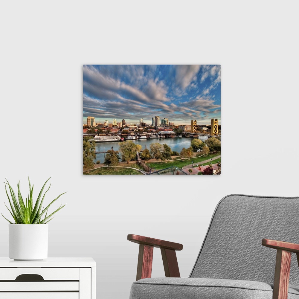 A modern room featuring Clouds over cityscape of  Downtown Sacramento at sunset.