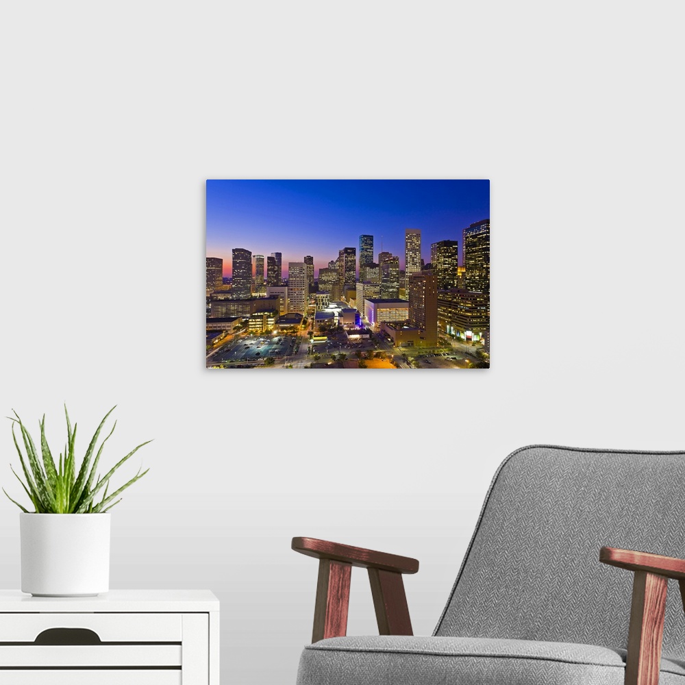 A modern room featuring Downtown city skyline at dusk/sunset/night, Houston, Texas, USA. Houston is the fourth largest ci...