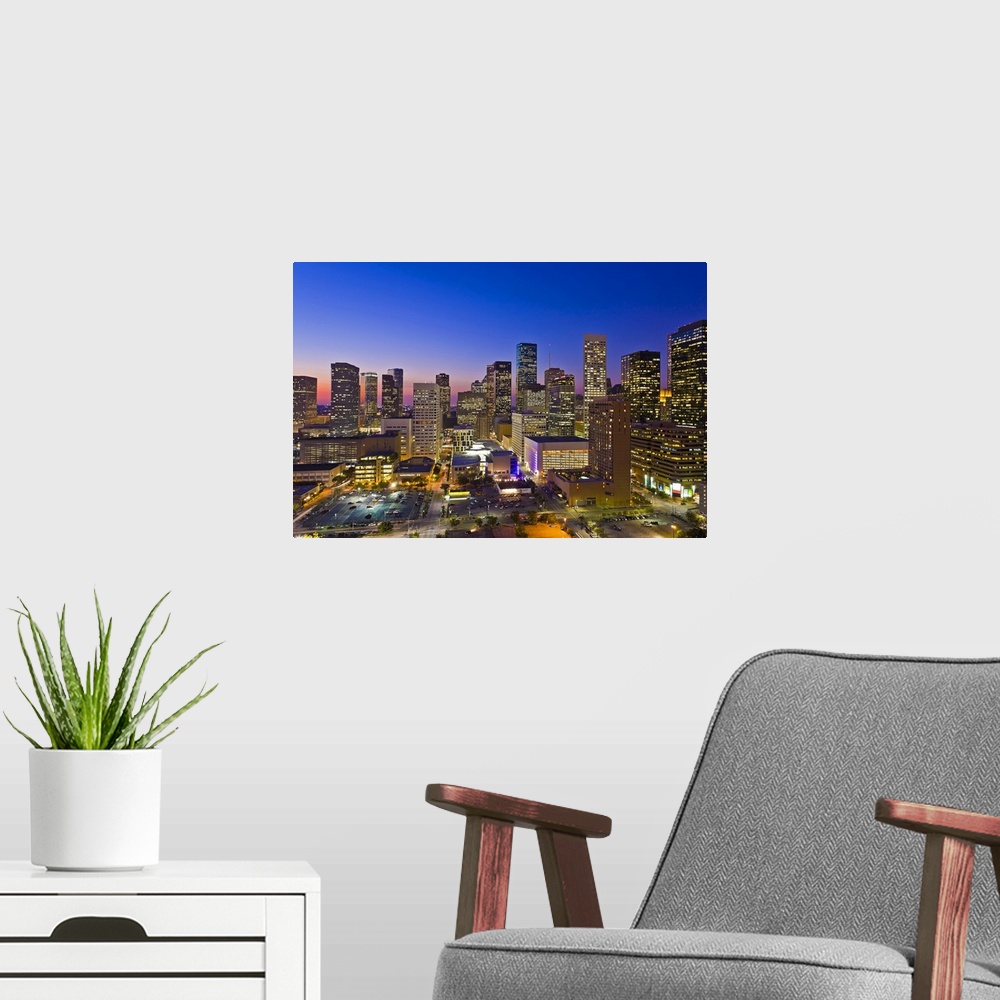 A modern room featuring Downtown city skyline at dusk/sunset/night, Houston, Texas, USA. Houston is the fourth largest ci...