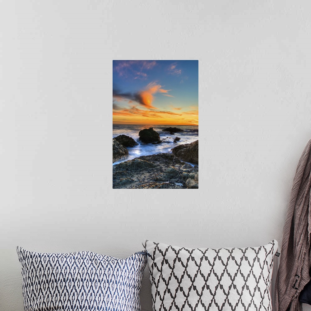 A bohemian room featuring Dramatic sunset on rocky beach in Malibu, California.