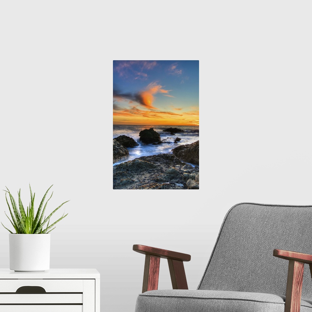 A modern room featuring Dramatic sunset on rocky beach in Malibu, California.